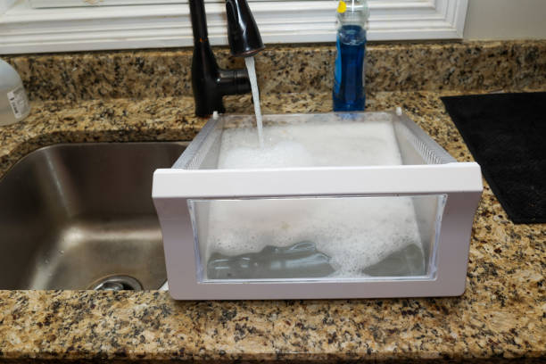 Cleaning refrigerator vegetable drawer in a kitchen sink