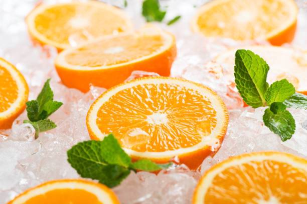 orange sliced on ice tube background
