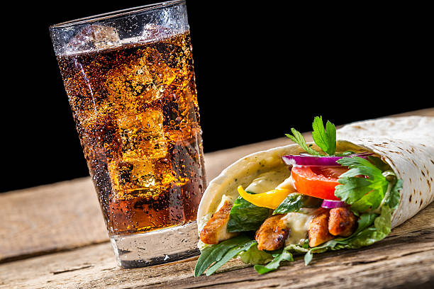Kebab with fresh vegetables and chicken on black background.
