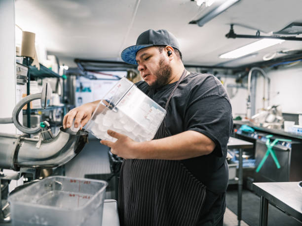 Young Mexican male chef working in restaurant kitchen.